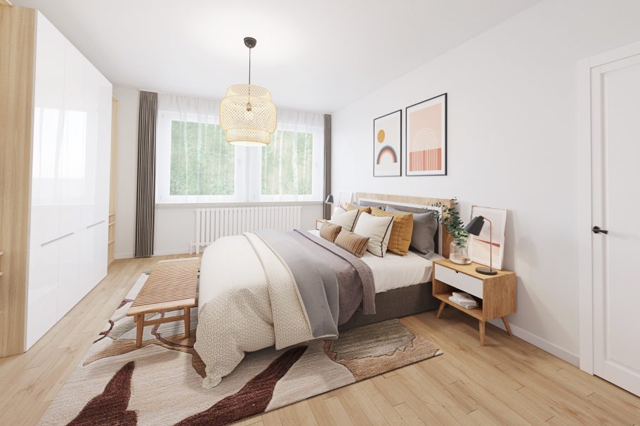 Helles Schlafzimmer mit einem Bett, einem Nachttisch und einem großen Fenster.