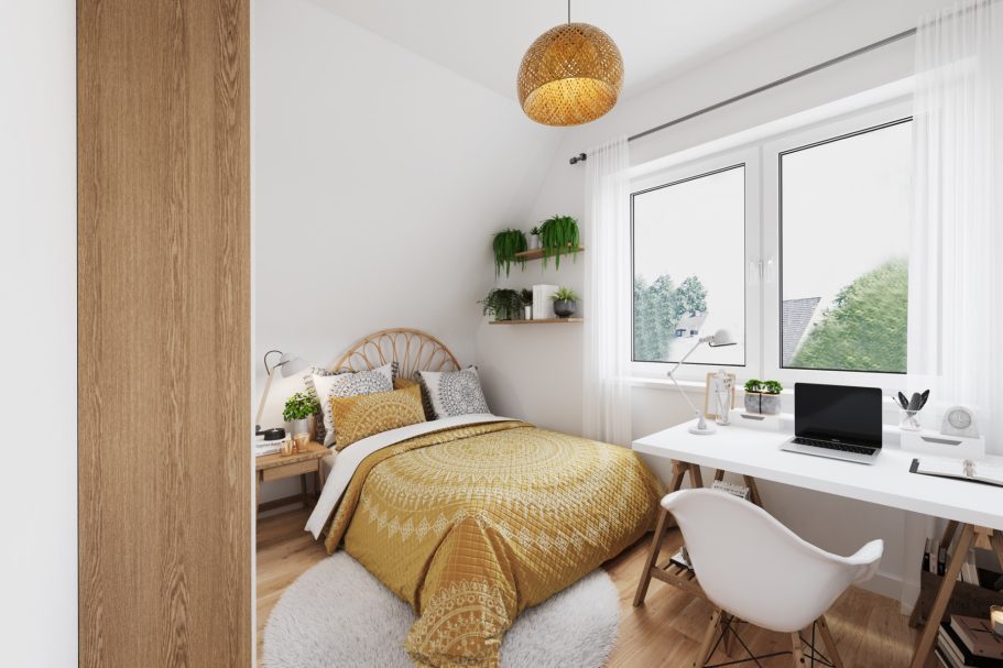 Helles Schlafzimmer mit einem Bett, Schreibtisch und Pflanzen an der Wand.